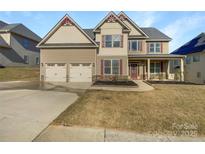 Charming two-story home featuring a two-car garage and craftsman-style details at 111 Chaffee Pl, Mooresville, NC 28115