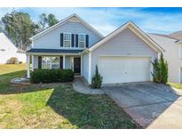 Charming two-story home with light gray siding, attached garage and manicured lawn at 1515 Kingdom Way, Indian Land, SC 29707