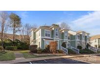 Beautiful exterior view of townhome featuring a lush front yard and ample parking at 17430 Tuscany Ln, Cornelius, NC 28031