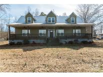 Inviting two-story home with a metal roof and a charming, spacious porch at 175 Riley'S Dr, Salisbury, NC 28146