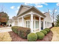 Charming home featuring well-manicured landscaping and a welcoming covered front porch with classic architectural details at 2036 Hudson Ln, Fort Mill, SC 29707