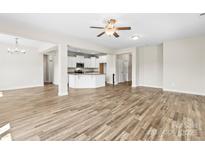 Spacious living room featuring modern wood floors and a seamless open-concept layout with access to the kitchen at 2504 Hovis Rd, Lincolnton, NC 28092