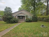 Charming single-story home with a well-maintained front yard and inviting walkway leading to the entrance at 5315 Airport Dr, Charlotte, NC 28208