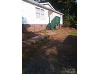 A modest home with white siding and a charming green-painted porch and steps at 630 Pinelake Dr, Troy, NC 27371