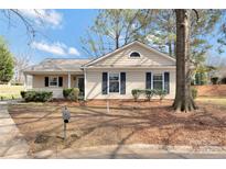 Charming single-story home with a welcoming front porch and well-maintained landscaping at 8701 Gainsford Ct, Charlotte, NC 28210