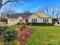 Charming single-story home with a well-manicured lawn and attached garage at 8723 Totteridge Dr, Charlotte, NC 28277