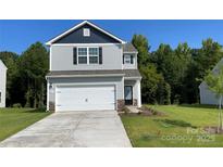 Charming two-story home with gray siding, a two-car garage, and a well-manicured lawn at 1055 Mordred St, Richburg, SC 29729