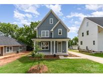 Inviting two-story home with a manicured lawn, covered porch, and well-maintained landscaping at 110 Walters St, Huntersville, NC 28078