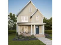Charming two-story home featuring a welcoming front porch with seating and manicured landscaping at 110 Walters St, Huntersville, NC 28078