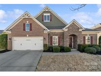Charming home with a brick and stone facade, two-car garage, and well-maintained landscaping at 119 Front Porch Dr # 46, Rock Hill, SC 29732