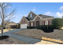 Beautiful home with brick and stone facade, red shutters, manicured lawn, and lovely curb appeal at 119 Front Porch Dr # 46, Rock Hill, SC 29732