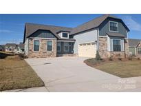 Charming home with a stone facade, neutral siding, well-manicured lawn and a spacious driveway at 1925 Hendricks St, Rock Hill, SC 29732