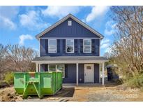 Charming two-story home featuring blue siding, black shutters, and a welcoming front porch at 230 Georgia Sw St # 63, Concord, NC 28025