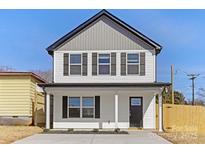 Charming two-story home featuring white siding, black shutters, and a welcoming front porch at 230 Georgia Sw St # 63, Concord, NC 28025