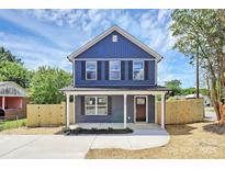 Charming two-story home featuring a covered front porch and newly landscaped front yard at 230 Georgia Sw St, Concord, NC 28025