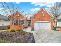 Charming brick home with a well-manicured lawn and an attached two-car garage at 23051 Kingfisher Dr, Fort Mill, SC 29707