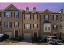 Charming brick townhomes featuring attached garages and beautiful architectural details at 243 Lincoln St, Charlotte, NC 28203