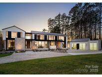 Stunning modern home with clean lines, stone accents, and a meticulously landscaped front yard at 2536 Brawley School Rd, Mooresville, NC 28117