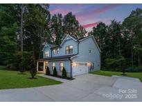 Charming two-story home with beautiful lawn and an attached garage, perfect for families at 3117 Williams Rd, Matthews, NC 28105