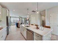Bright, open kitchen with a large island, stainless steel appliances, and seamless flow to the living area at 344 Catawba Ave, Davidson, NC 28036