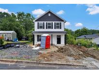 Charming two-story home with black and white exterior paint, black window shutters, and landscaping to be finished at 425 Messner St, Salisbury, NC 28144