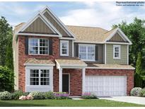 Two-story home featuring brick and siding, an attached garage and a well-manicured lawn at 4625 Potters Wheel Dr, Fort Mill, SC 29715
