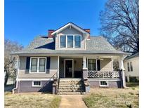 Charming two-story home featuring a welcoming front porch, stone steps, and a well-maintained yard at 214 Maupin Ave, Salisbury, NC 28144