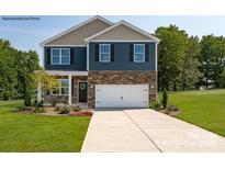 Charming two-story home boasts a stone-accented facade, well-manicured lawn, and an attached two-car garage at 327 Brinkley Dr # 106, Kings Mountain, NC 28086
