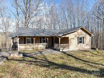 Charming single-story home featuring a welcoming front porch and a well-maintained yard with mature trees at 2974 Jenkins Rd, Lincolnton, NC 28092