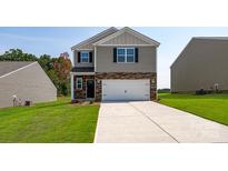 Two-story home featuring stone accents, a two-car garage, and a well-manicured lawn at 321 Brinkley Dr # 106, Kings Mountain, NC 28086