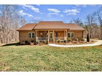 Charming brick home with a covered front porch and well-maintained landscaping, providing curb appeal at 809 Liberty Rd, Gold Hill, NC 28071
