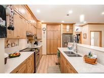 Well-lit kitchen featuring wood cabinets, stainless steel appliances, and white countertops at 809 Liberty Rd, Gold Hill, NC 28071