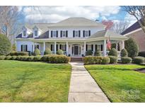 Charming two-story home with well-manicured lawn and symmetrical landscaping at 9128 Summer Club Rd, Charlotte, NC 28277