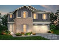 Charming two-story home with a two-car garage, brick accents, and beautifully landscaped yard at 9481 Coast Laurel Ave # 12, Concord, NC 28027