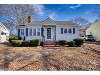 Charming single-story home with blue shutters, manicured bushes, brick chimney, and inviting front entrance at 111 Courtland St, Chester, SC 29706