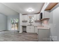Bright kitchen features white cabinets, marble countertops, and stainless steel microwave at 313 Villa St, Kannapolis, NC 28083