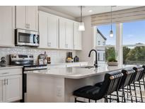 Bright kitchen featuring white cabinets, subway tile backsplash, quartz countertops, and stainless steel appliances at 3222 Stelfox St, Charlotte, NC 28262