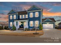 Charming two-story home featuring a well-manicured front yard and a two-car garage at 388 Luray Way, Rock Hill, SC 29730
