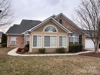 Charming stone and siding home featuring a manicured lawn and attached garage at 5518 Prosperity View Dr, Charlotte, NC 28269