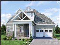Charming single-Gathering home showcasing a two-car garage, stone accents, and a well-manicured front yard with a gable entryway at 7443 Paddle Ln # 55, Sherrills Ford, NC 28673