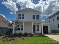 Inviting two-story home showcasing a charming front porch with classic white columns at 7459 Fighting Creek Rd # 33, Sherrills Ford, NC 28673