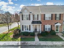 Charming townhome featuring a well-manicured lawn and neutral siding with stylish contrasting shutters at 8004 Sapwood Ct, Matthews, NC 28104