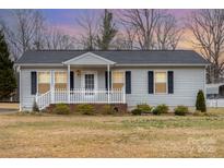 Charming single-story home with a white picket fence and well-maintained front yard at 11918 Crabapple Ln, Huntersville, NC 28078