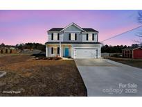 Two-story home featuring gray siding, a blue front door, and an attached two-car garage with a long driveway at 147 Stanfield Farm Ln, Stanfield, NC 28163