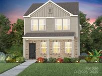 Charming two-story home boasts a brick facade, well-manicured lawn and beautiful landscaping at 3604 Pamlico St # 128, Monroe, NC 28110