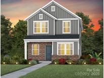 Two-story home boasts a modern design, gray siding, brick facade and front yard with manicured landscaping at 3608 Pamlico St # 127, Monroe, NC 28110