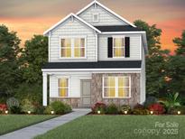 Charming two-story home featuring a stone and shingle facade with a well-maintained lawn and landscaping at 3612 Pamlico St # 126, Monroe, NC 28110