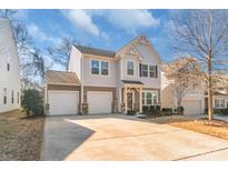 Charming two-story home with a three-car garage, well-maintained landscaping, and inviting front porch at 8028 Tricia Pointe Pl, Indian Land, SC 29707