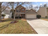Charming two-story home with a two-car garage, brick accents and a well-manicured lawn at 9014 Arbor Creek Dr, Charlotte, NC 28269