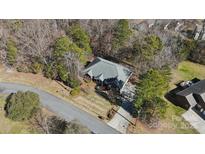 Aerial view of house surrounded by mature trees and long driveway at 10620 S Ford Rd, Charlotte, NC 28214